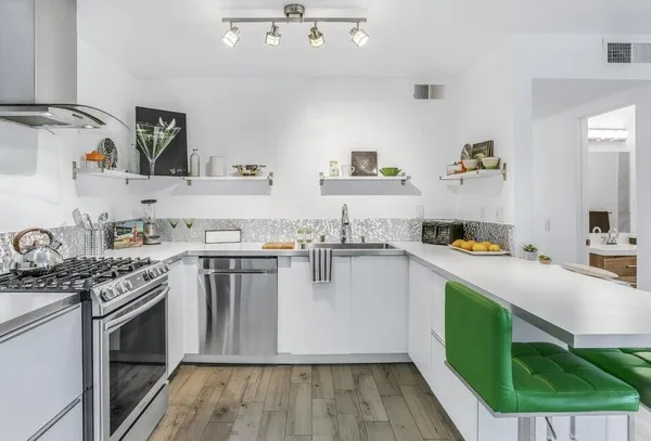 a kitchen with a sink cabinets and wooden floor