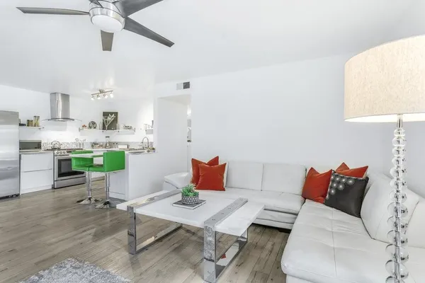 a living room with furniture and kitchen view