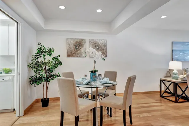 a view of a dining room with furniture and wooden floor