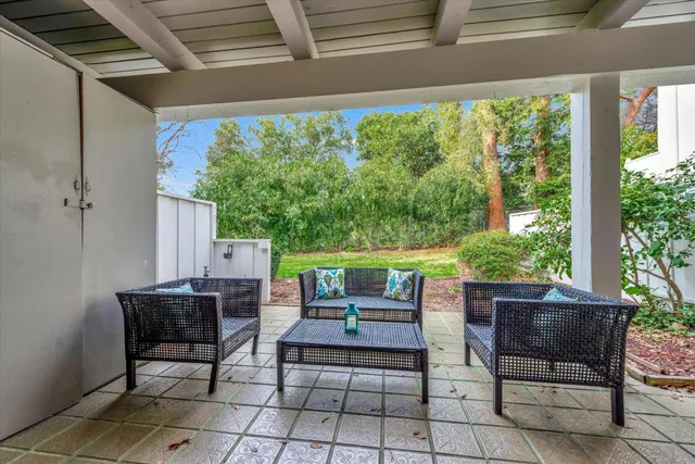 a view of a porch with furniture and garden