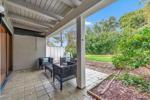 a view of a building with a chairs in patio