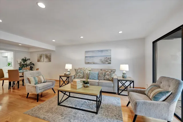 a living room with furniture and a potted plant