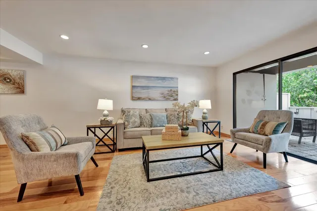 a living room with furniture potted plant and a table