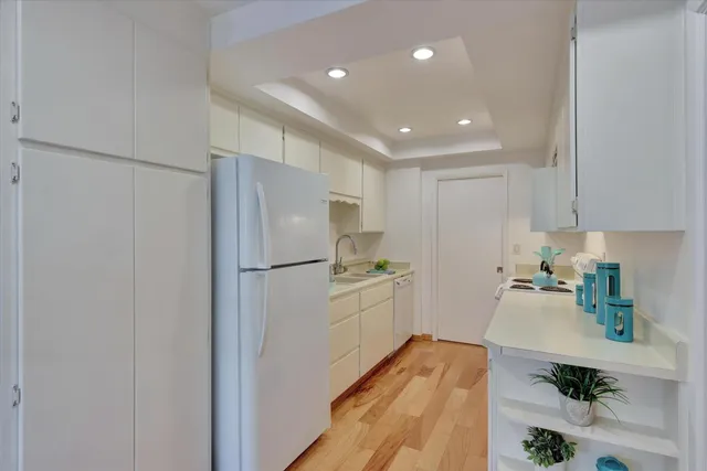a kitchen with a sink a stove and cabinets