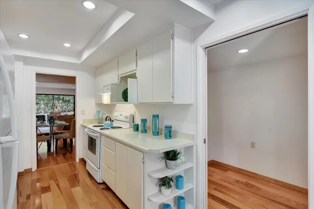 a kitchen with a sink a stove and cabinets