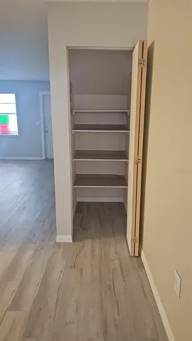 a view of walk in closet with empty racks