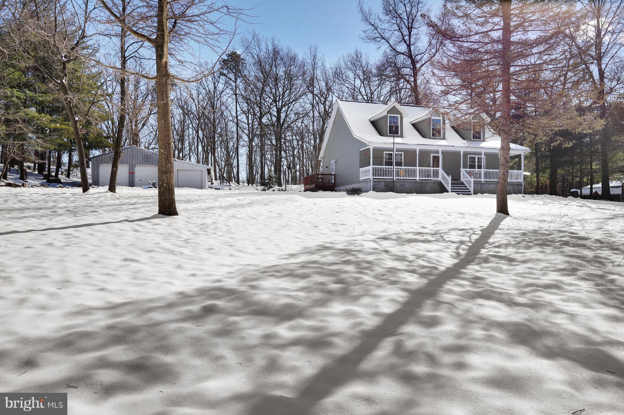 12315 Forrest Hill Road Clear Spring, MD 21722 - Photo 3 of 37 a front view of a house with a yard covered with snow