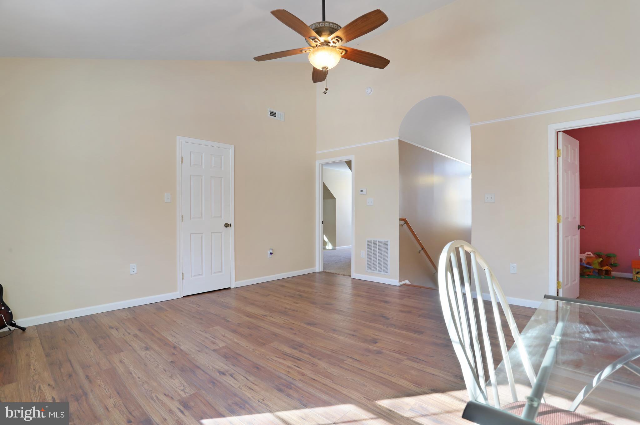 12315 Forrest Hill Road Clear Spring, MD 21722 - Photo 23 of 37 a view of an empty room with wooden floor and a ceiling fan