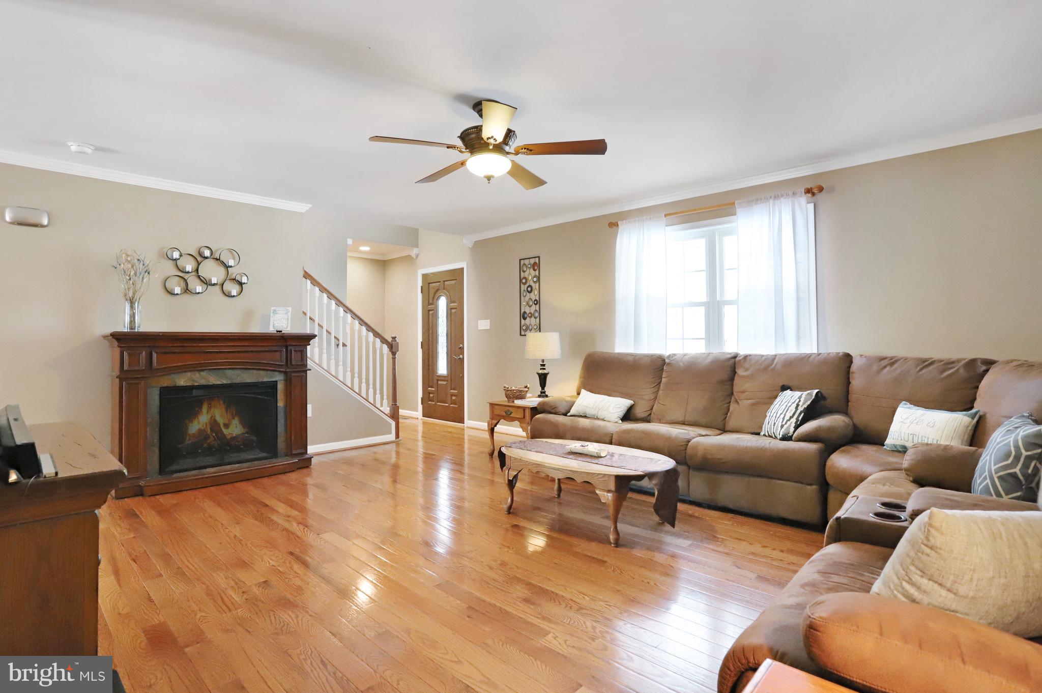 12315 Forrest Hill Road Clear Spring, MD 21722 - Photo 5 of 37 a living room with furniture a fireplace and a flat screen tv
