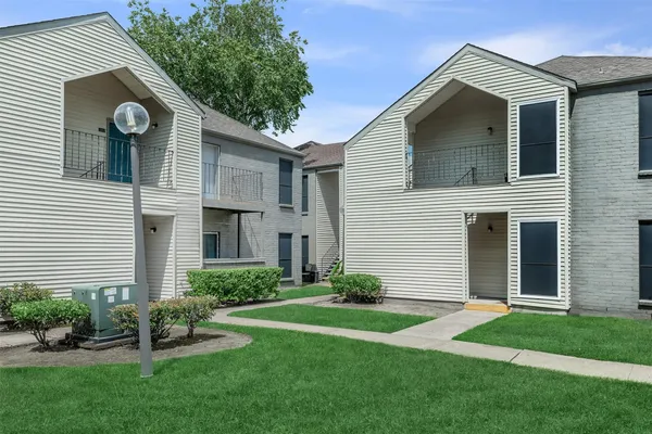 a view of a house with swimming pool and sitting area