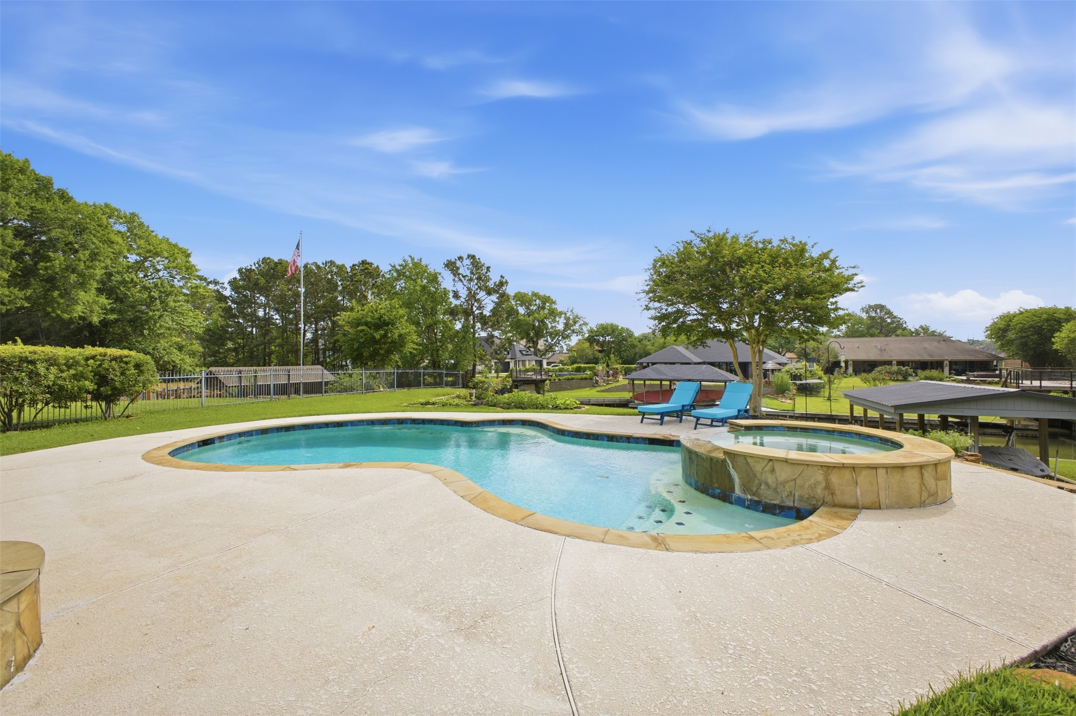 12710 Aries Loop Willis, TX 77318 - Photo 36 of 40 This property features an inviting swimming pool with an integrated spa, surrounded by a spacious concrete patio