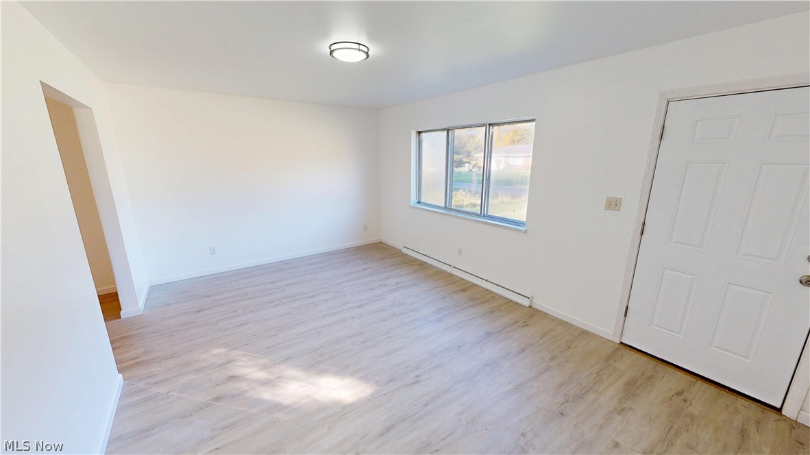 693 Liberty Road Youngstown, OH 44505 - Photo 3 of 14 Light wood-finish flooring, white walls, and a multi-pane window