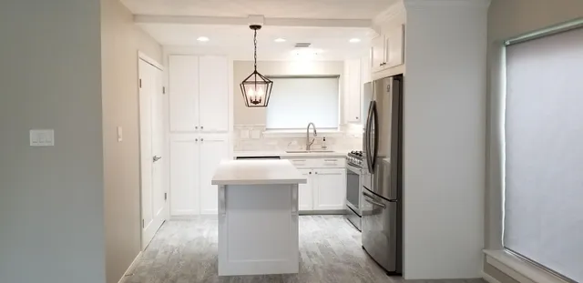 a bathroom with a sink a mirror and a shower