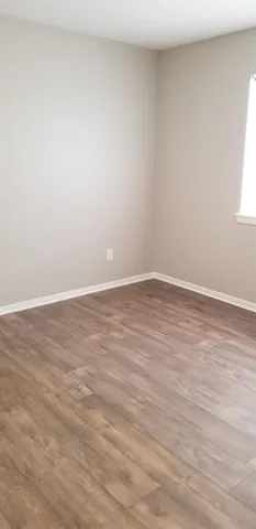 a view of a closet with wooden floor