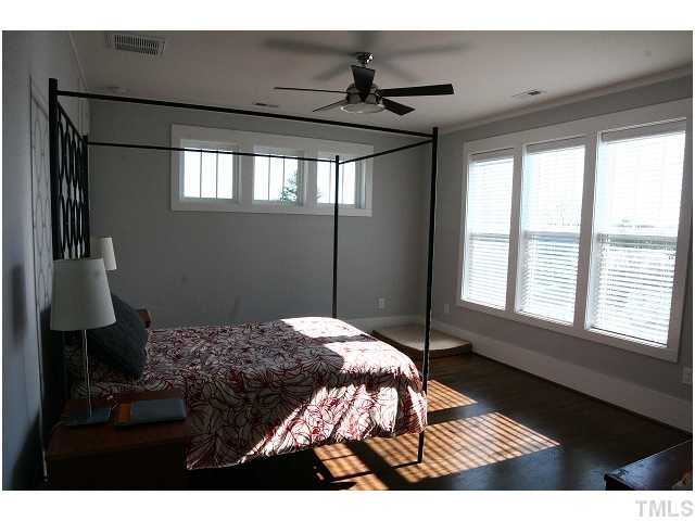 315 Georgetown Road, Unit H Raleigh, NC 27608 - Photo 12 of 20 a bedroom with a bed next to a window