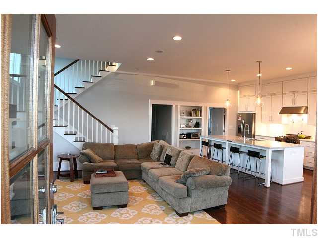 315 Georgetown Road, Unit H Raleigh, NC 27608 - Photo 3 of 20 a living room with furniture kitchen view and a wooden floor