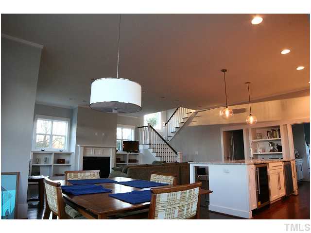 315 Georgetown Road, Unit H Raleigh, NC 27608 - Photo 5 of 20 a living room with furniture a fireplace and kitchen view