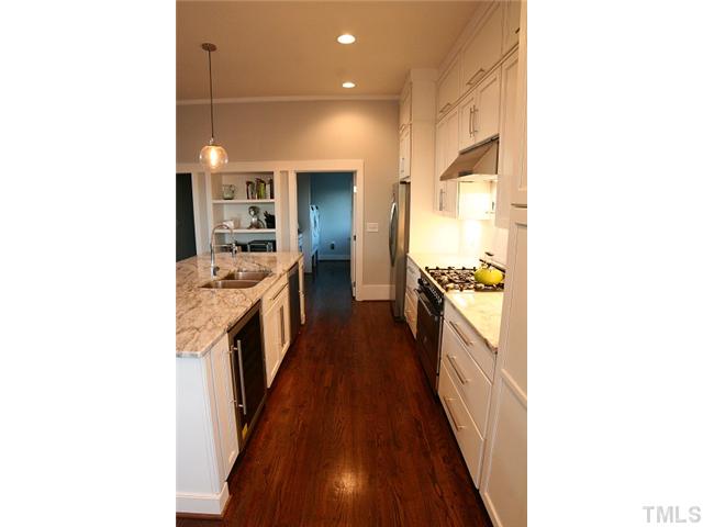 315 Georgetown Road, Unit H Raleigh, NC 27608 - Photo 9 of 20 a view of a kitchen from the hallway