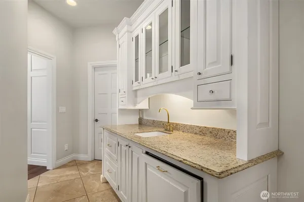a kitchen with granite countertop a sink and cabinets