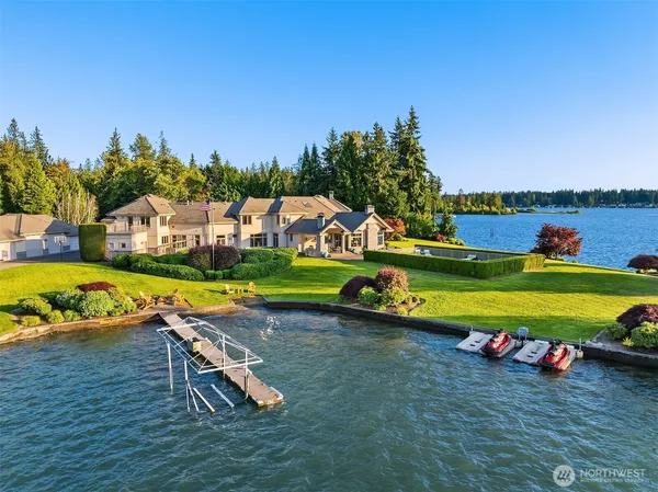 a view of a swimming pool with lawn chairs and a yard
