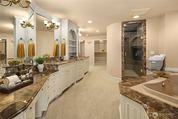 a bathroom with a granite countertop sink a toilet and mirror
