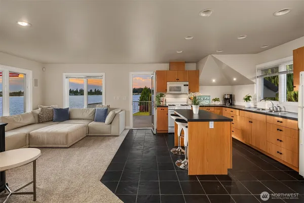 a living room with furniture a kitchen view and a sink