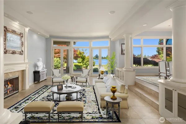 a living room with fireplace furniture and a large window