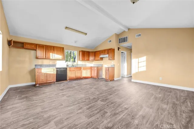 a view of a refrigerator in kitchen and wooden floor
