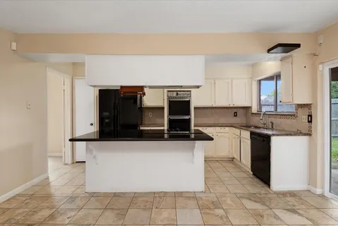a view of a kitchen with a sink and a stove top oven