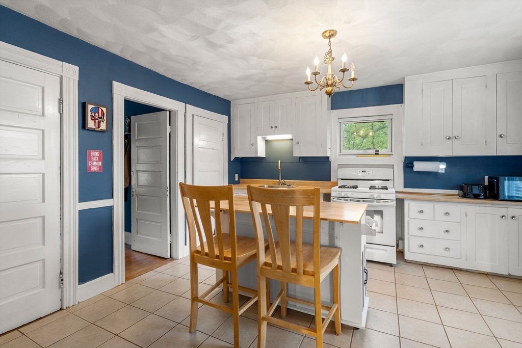 26 Powder Mill Road Maynard, MA 01754 - Photo 7 of 16 a kitchen with cabinets and chairs