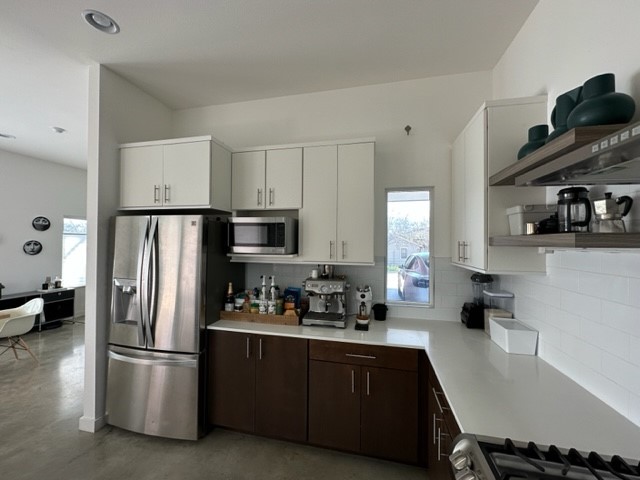 5501 Link Avenue, Unit A Austin, TX 78751 - Photo 11 of 30 a kitchen with stainless steel appliances a refrigerator a sink a stove and white cabinets