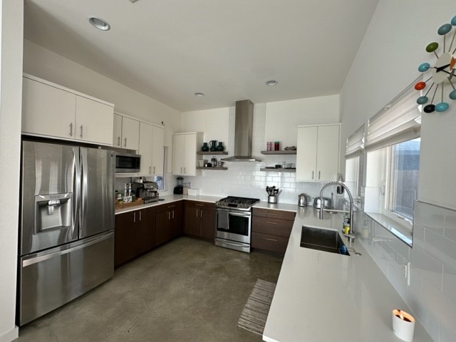 5501 Link Avenue, Unit A Austin, TX 78751 - Photo 10 of 30 a kitchen with stainless steel appliances granite countertop a refrigerator a sink dishwasher a stove a oven a dining table and chairs with wooden floor