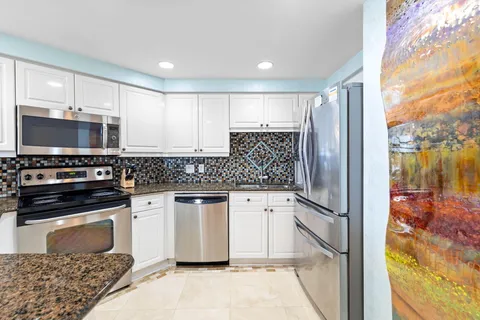 a spacious bedroom with a bed and a flat screen tv