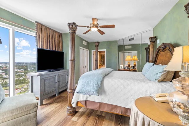 a bathroom with a granite countertop sink mirror vanity and toilet