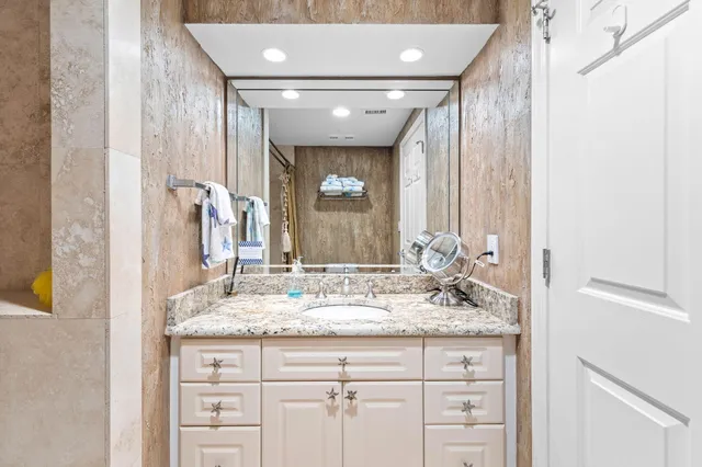 a spacious bathroom with a granite countertop sink mirror and double