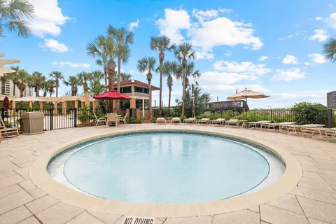 an aerial view of a house with a garden and swimming pool
