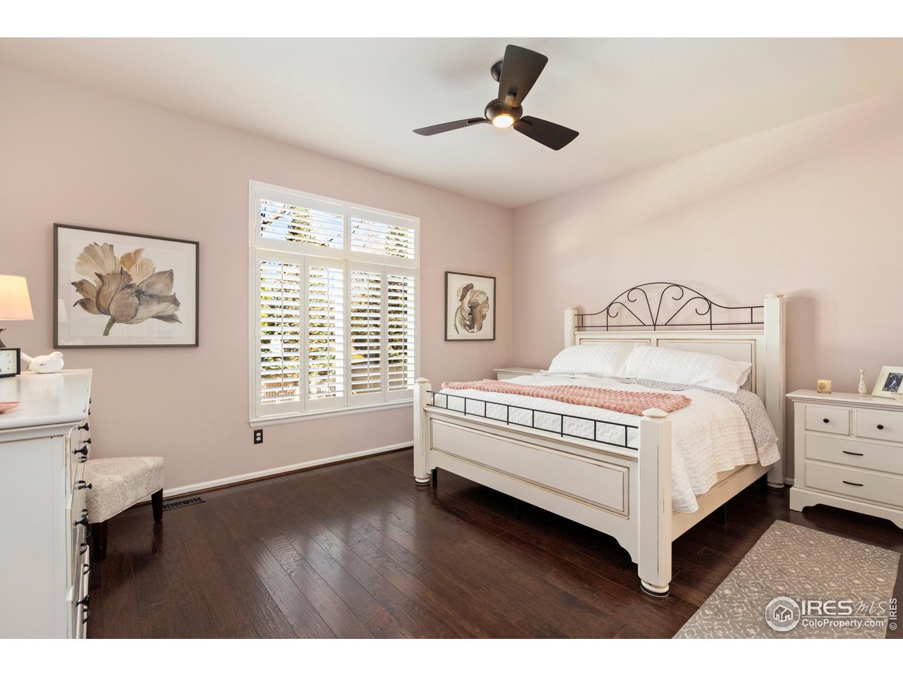 6685 Sage Avenue Firestone, CO 80504 - Photo 14 of 22 a bedroom with a bed chandelier and a window