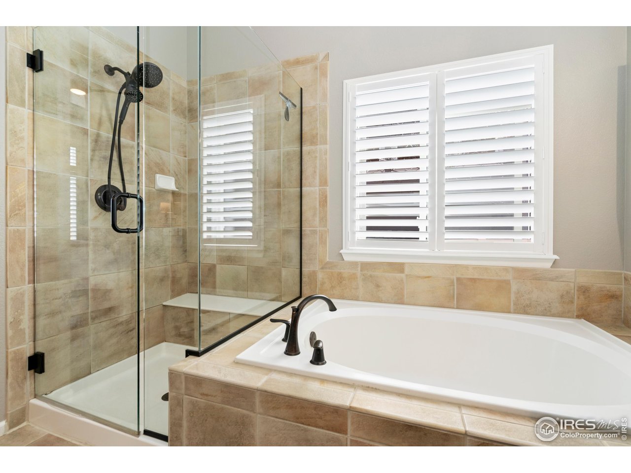 6685 Sage Avenue Firestone, CO 80504 - Photo 17 of 22 a bathroom with a tub and a shower