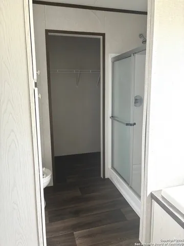 a view of a hallway with wooden floor