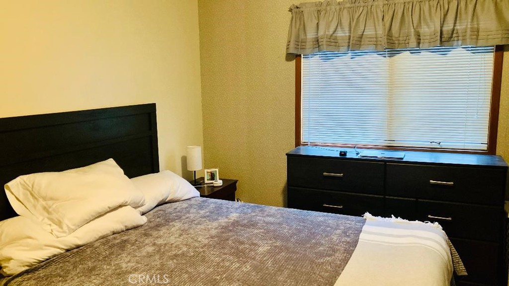 4920 Tippytoe Lane Forest Ranch, CA 95942 - Photo 25 of 36 a bedroom with a bed and a dresser