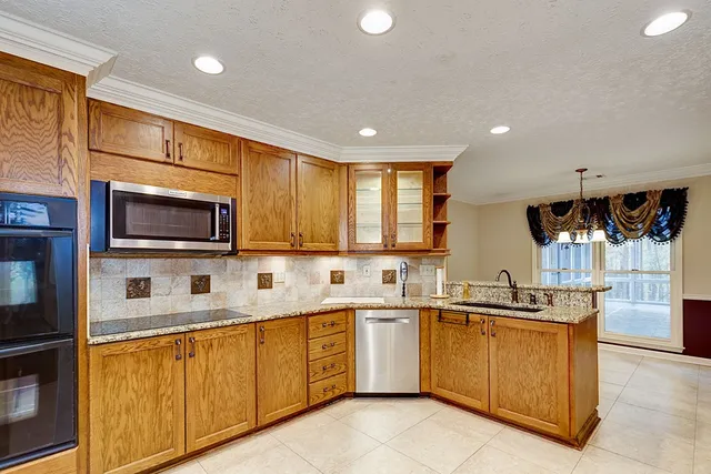 a kitchen with a sink a stove and cabinets