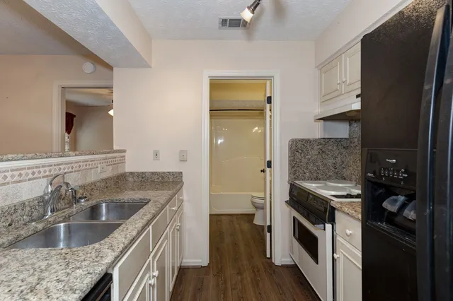 a kitchen with a stove and a sink
