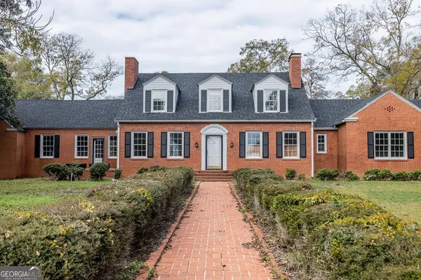 a front view of a house with a yard
