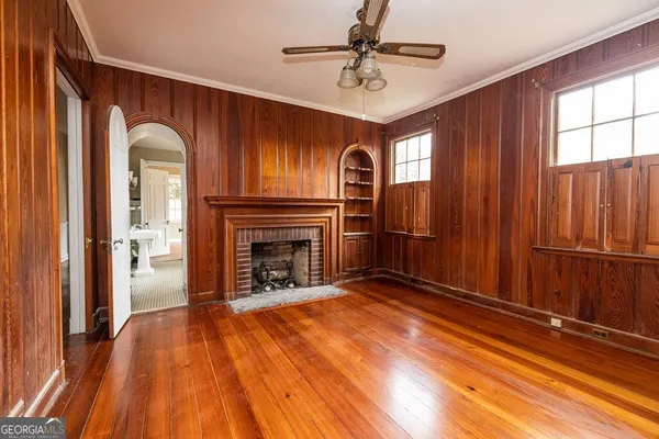 a view of a livingroom with a fireplace wooden floor and window