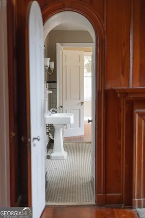 a view of a hallway with entryway wooden floor and front door