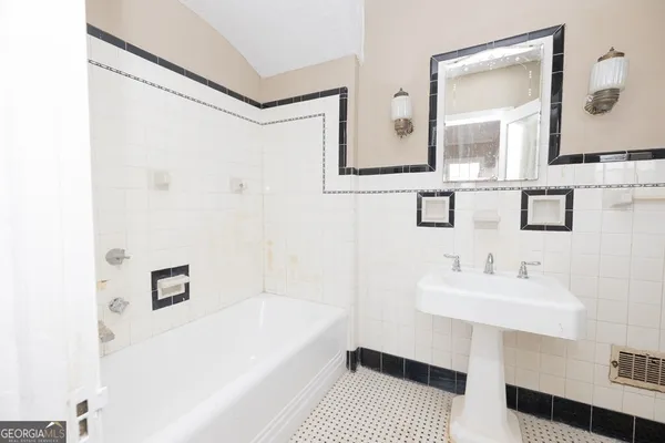 a bathroom with a sink a mirror and a bathtub
