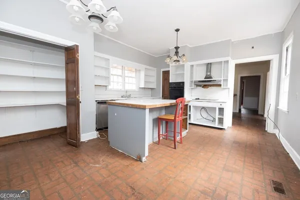 a view of a kitchen with cabinets and a floor to ceiling window