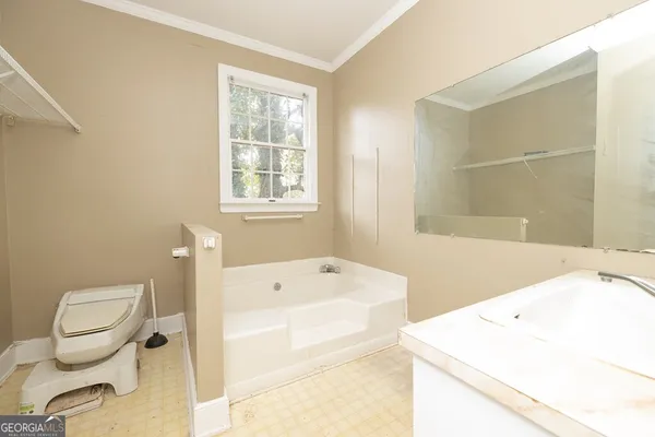 a bathroom with a sink a toilet and bathtub