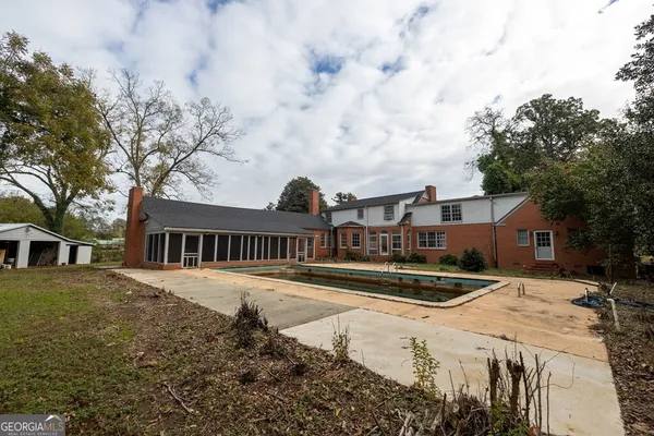 a front view of a house with yard and trees