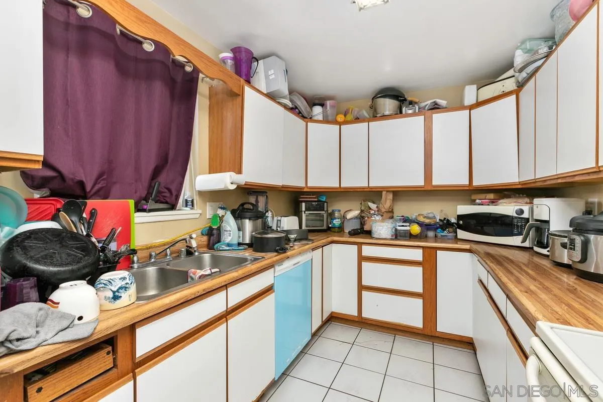 9136 Northcote Road Santee, CA 92071 - Photo 4 of 10 a kitchen with a sink appliances cabinets and a window